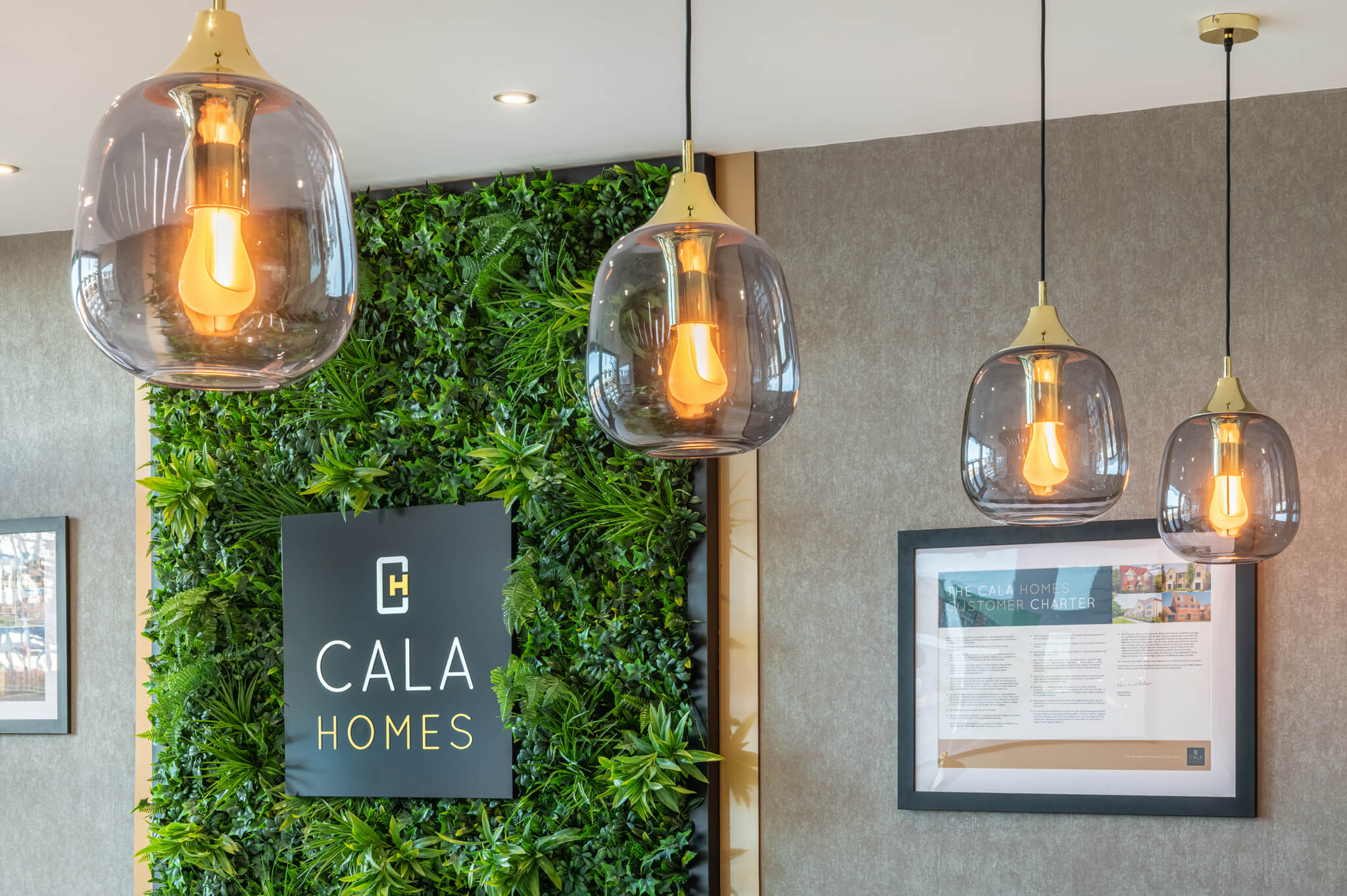 Cala Homes sign on a artificial plant backdrop