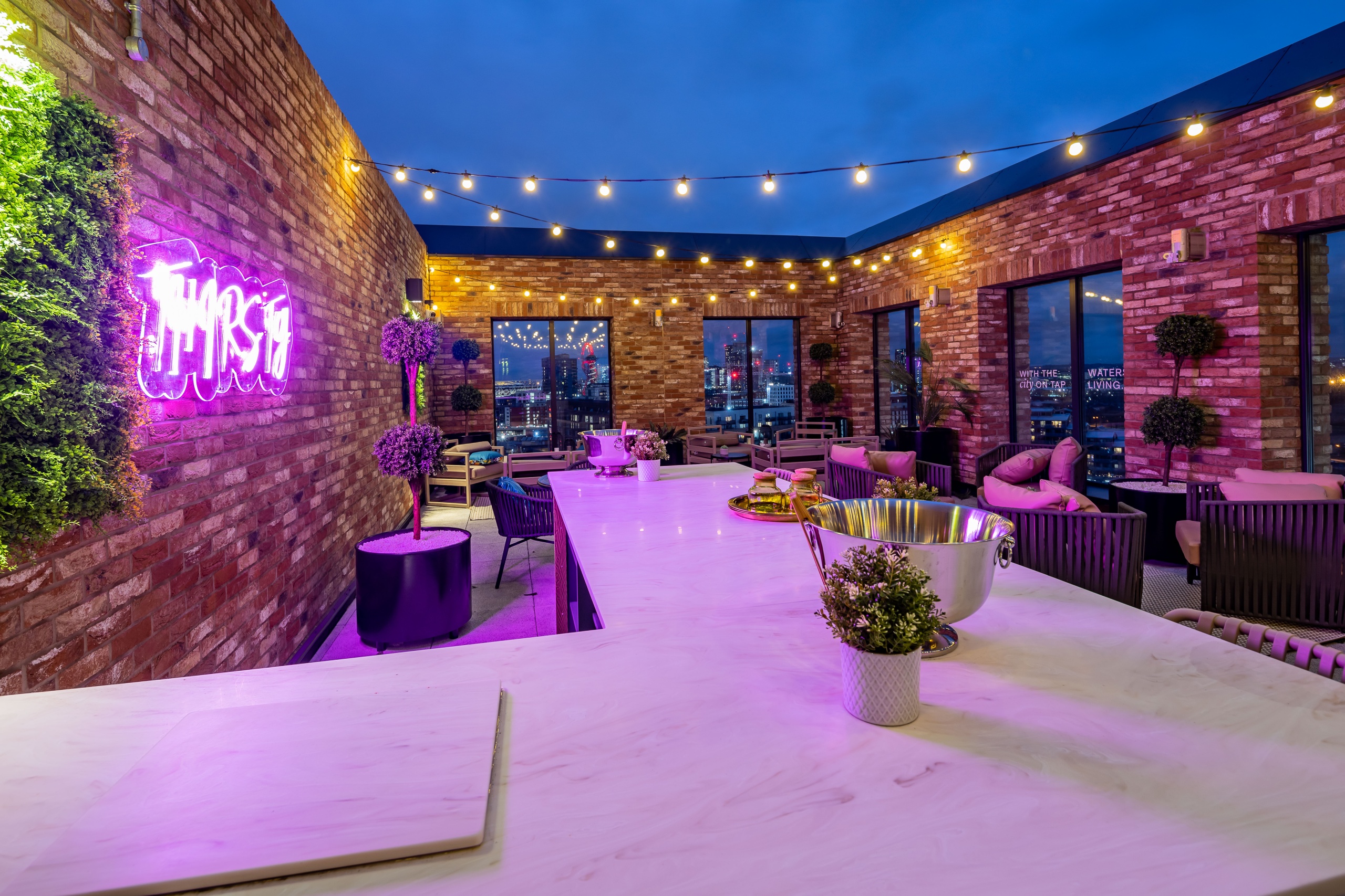 Rooftop terrace with bar and lots of seats that overlook the city