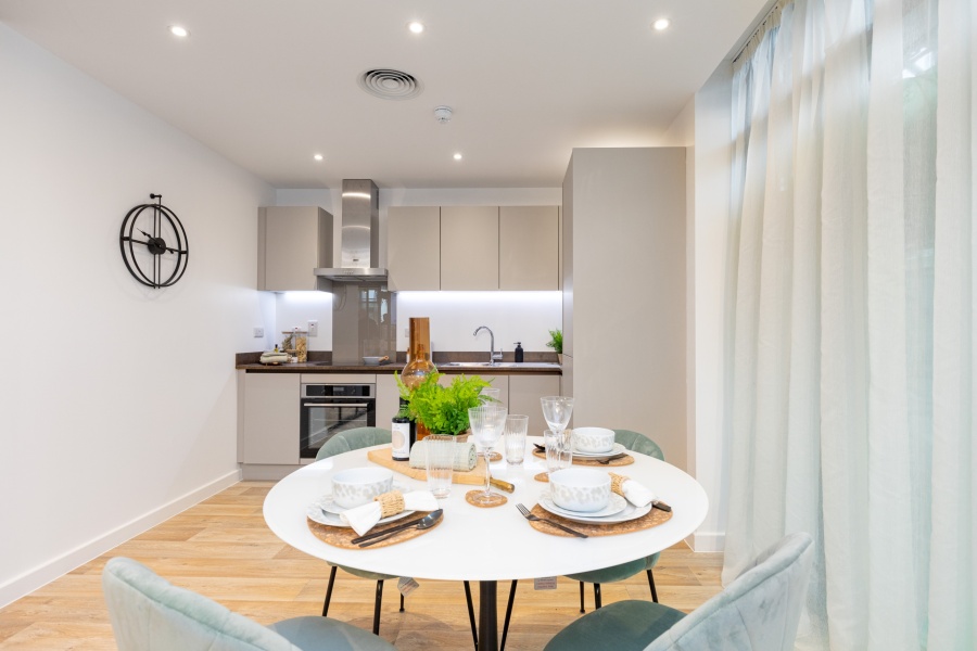 modern Kitchen dining area with a round dinner table and four chairs placed around it