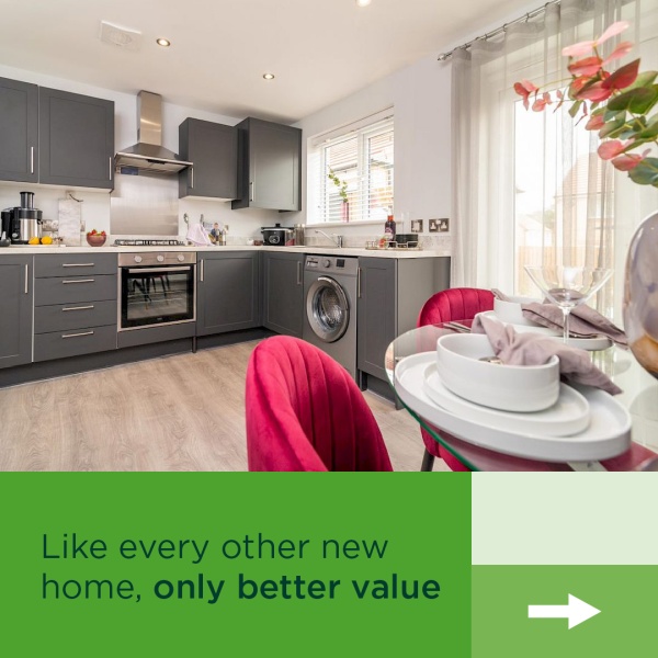 A spacious kitchen with grey cabinets and a glass patio door leading to the garden