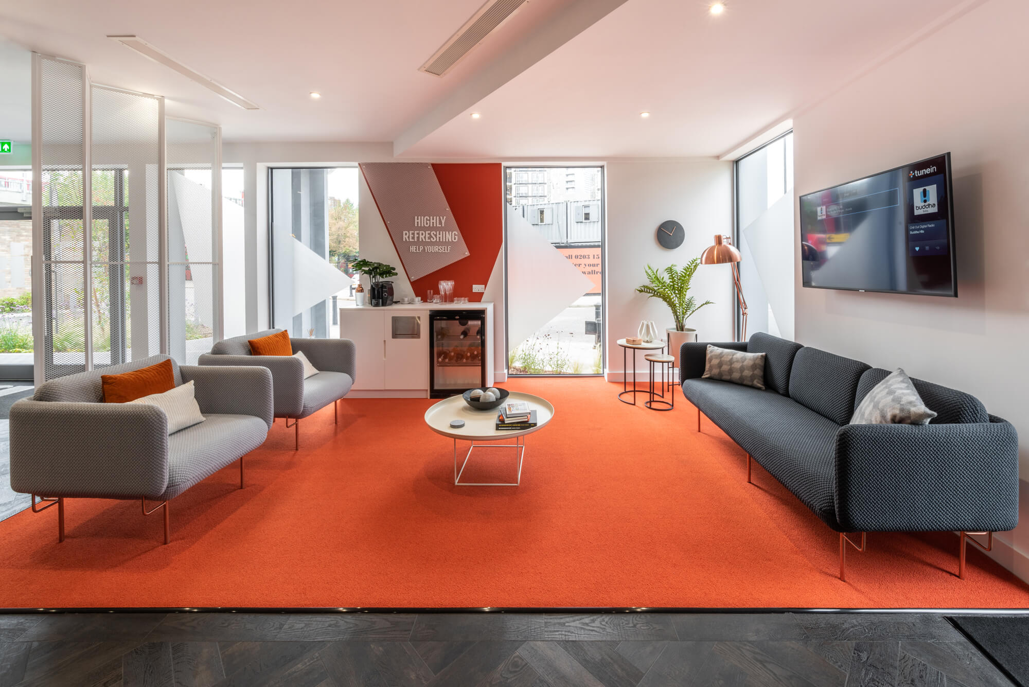 Seating area with a mini bar and wall mounted TV