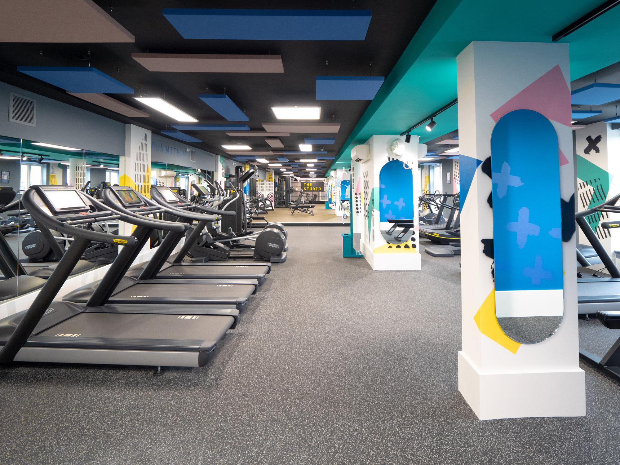Bright coloured gym with cardio and weight lifting equipment