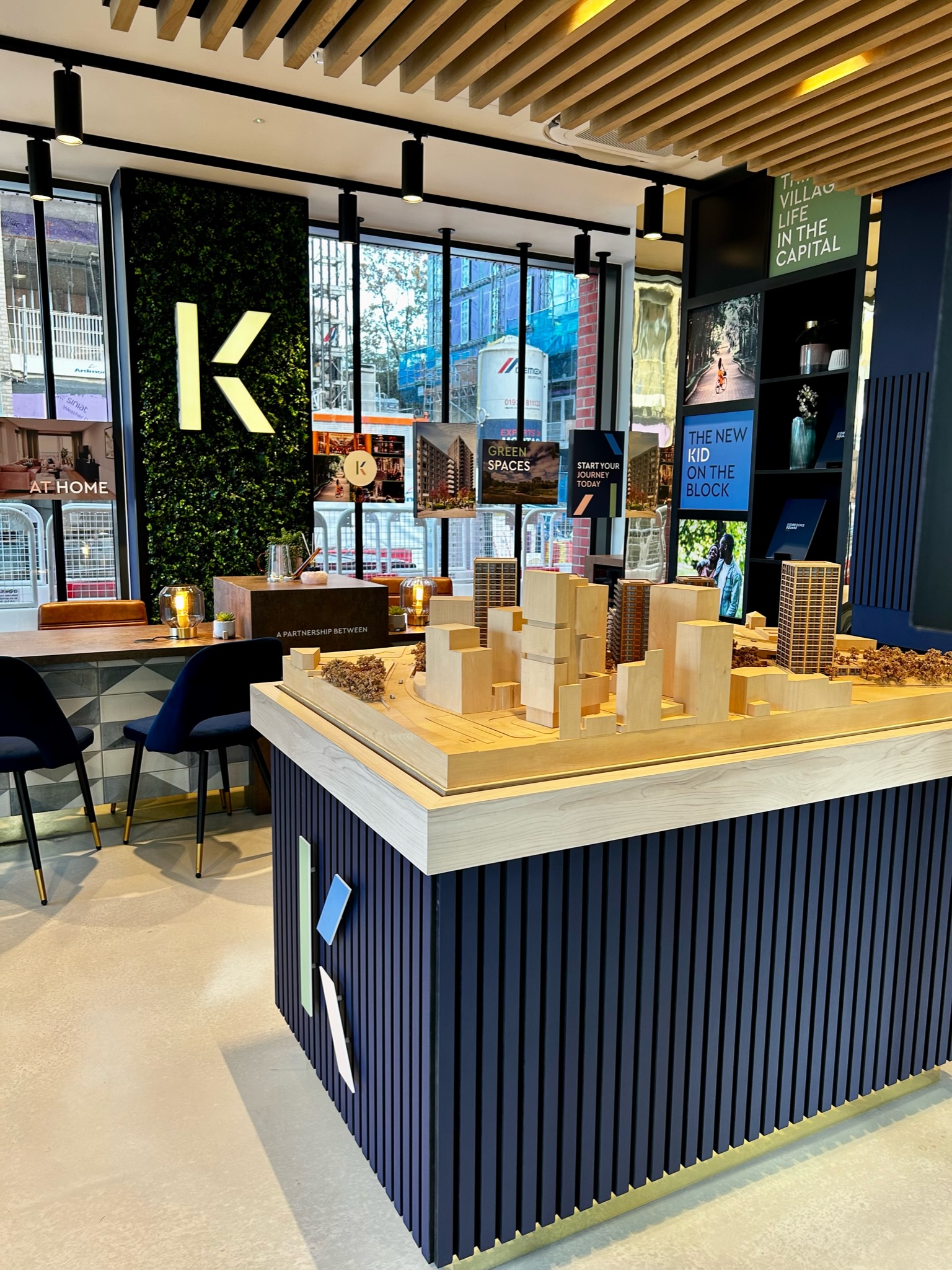 marketing suite with a large 3D model of the city around the development and various images of the development
