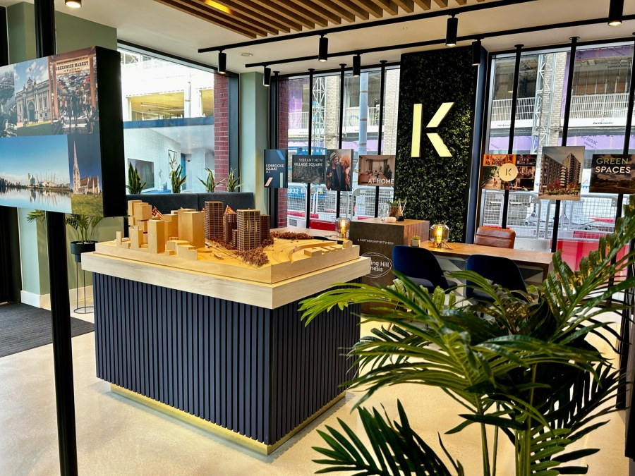 marketing suite with a large 3D model of the city around the development and various images of the development